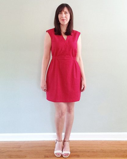 Woman wearing the Ava Dress sewing pattern by Pattern Scout. A sleeveless dress pattern made in linen, cotton sateen/lawn/batiste/chambray, rayon, lyocell or Tencel fabrics, featuring a faux wrap bodice, elasticated waist, above knee length finish and V-neck.