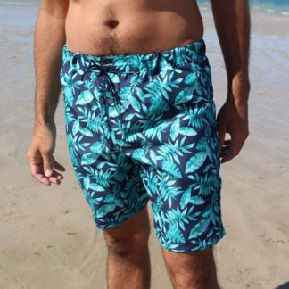Man wearing the Men's Marin Swim Shorts sewing pattern from Etoffe Malicieuse on The Fold Line. A swim shorts pattern made in swim shorts fabric / men’s swimwear fabric, featuring an inner lining, faux fly and elasticated waist that sits below the waist.