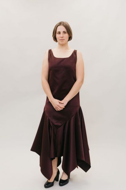 Woman wearing the 264 Monte Carlo Dress sewing pattern from Folkwear on The Fold Line. A sleeveless, flapper styled, sheath dress pattern made in lightweight and/or sheer silk, rayon, polyester, novelty velvets and jacquard fabrics, featuring straight sides, dropped waist, handkerchief hem and square neckline.