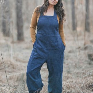 Woman wearing the Otis Overalls sewing pattern by Sew Liberated. A dungaree pattern made in mid-weight woven fabrics, such as linen, gabardine, lightweight twill or denim, linen or silk noil fabrics, featuring shaped seams on the lower leg and an ankle-length lantern cuff, relaxed fit, dropped crotch, roomy pockets and a drawstring back waist closure for pull-on comfort and ease.