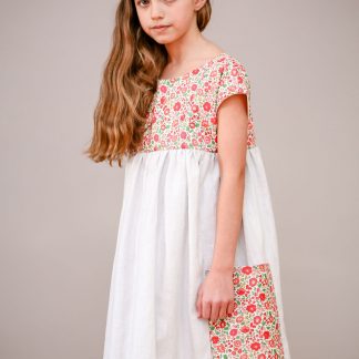 Child wearing the Children's Portobello Pocket Dress sewing pattern by Greyfriars and Grace. A dress pattern made in cotton, linen or cotton/linen blend fabric for dress and lining, featuring a relaxed fit, two large side pockets and a button back closure.