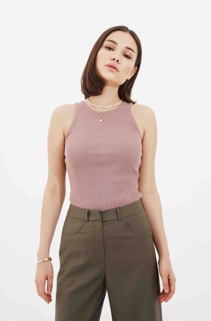Woman wearing the Veronica Top sewing pattern by Vikisews. A sleeveless top pattern made in cotton jersey, rib knits, bamboo jersey, ITY knits, viscose jersey, spandex or sweater knit fabrics, featuring a tight fit and rounded neckline.