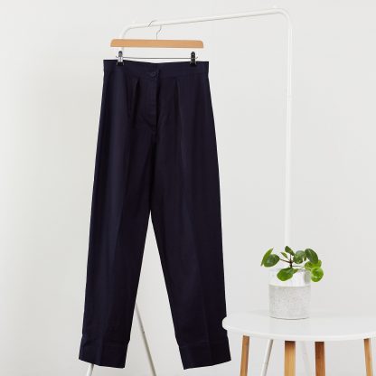 The Bogan Trousers sewing pattern from PH7 Patterns on The Fold Line. A trouser pattern made in cotton and cotton mix, linen and linen mix fabrics, featuring a button and zip fly closure, mid-rise waist band, front pleats and tapered leg.