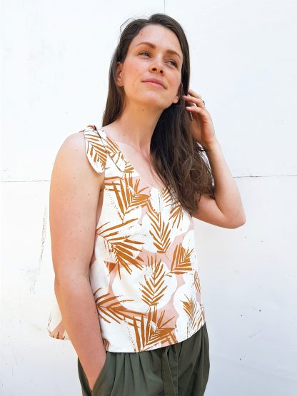 Woman wearing the Frankie Tankie sewing pattern from Vanessa Hansen on The Fold Line. A sleeveless top pattern made in viscose and blends, cottons lawn, double gauze, silks or lightweight linen fabrics, featuring a loose fit, slightly cropped length, deep armholes, shoulder ties and scooped neckline.