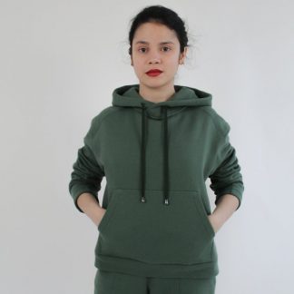 Woman wearing the Interstellar Hoodie sewing pattern from Bella Loves Patterns on The Fold Line. A hoodie pattern made in sweatshirting, French terry, Ponte Roma or cotton fleece fabrics, featuring a moderate oversized fit, angled shoulder yoke, two-piece tapered sleeve, front kangaroo pocket and deep hood.