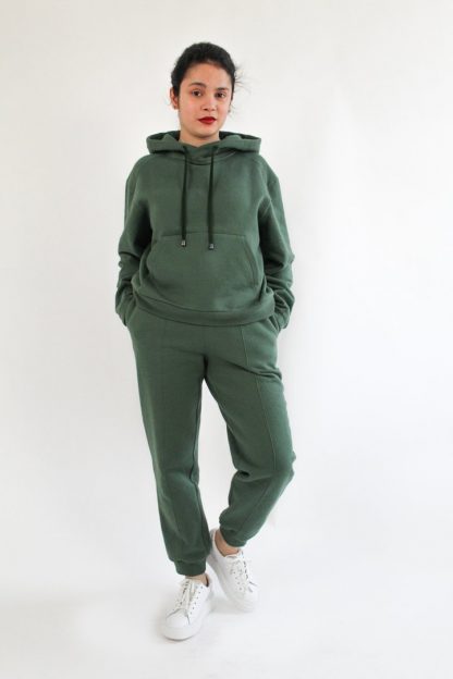 Woman wearing the Luna Joggers sewing pattern from Bella Loves Patterns on The Fold Line. A joggers pattern made in sweatshirting, French terry, Ponte Roma and double knits with cross-wise stretch, featuring a high waist, straight leg, in-seam side pockets and elastic waistband with drawstring.