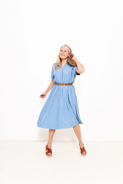 Women wearing the Taylor Dress sewing pattern from Fibre Mood on The Fold Line. A dress pattern made in cotton, viscose, linen, polyester blends or light wool fabrics, featuring shaped sleeves with sleeve trim, a slot neckline with a slight fold, A-line silhouette and an elasticised waist.