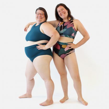 Women wearing the Sandpiper Swimsuit sewing pattern from Helens Closet on The Fold Line. A two-piece swimsuit pattern made in swimwear stretch knit fabrics, featuring a high-waist, low-rise bottoms and scoop neckline.