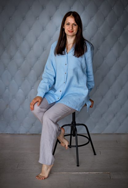 Woman wearing the Coco Shirt sewing pattern from Kates Sewing Patterns on The Fold Line. A shirt pattern made in cotton, linen, silk or viscose fabrics, featuring a wide straight cut, back yoke, front button placket, pyjama-style collar, patch pocket, cuffs and pleats on sleeves.