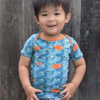 Child wearing the Free Baby/Child Lunar T-shirt sewing pattern from Waves & Wild on The Fold Line. A Tee pattern made in cotton/Lycra jersey fabrics, featuring an envelope neck, short sleeves and slim fit.