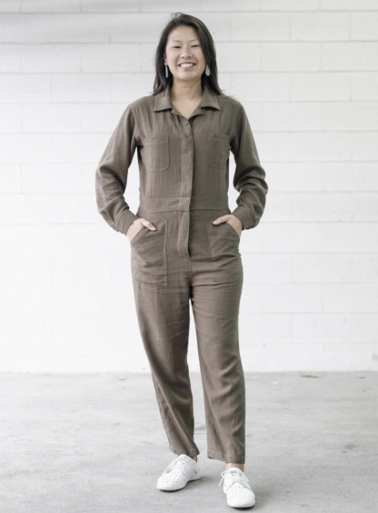 Woman wearing the Melrose Boiler Suit sewing pattern from Style Arc on The Fold Line. A boilersuit pattern made in drill, washed linen, denim or crepe fabrics, featuring a button front, long sleeves with button cuffs, doubled back yoke, shirt collar with collar stand, and patch pockets.
