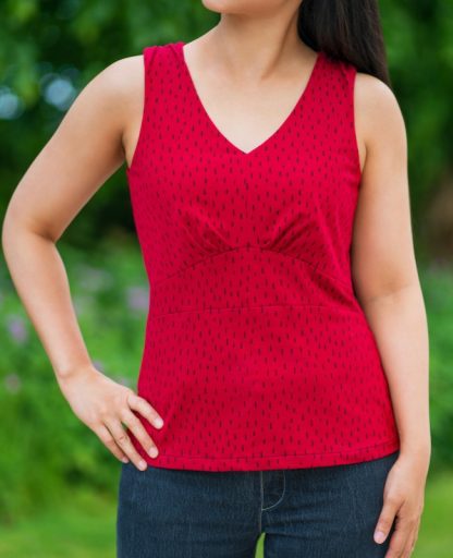 Woman wearing the Spirren Tank sewing pattern from Itch to Stitch on The Fold Line. A tank pattern made in cotton spandex jersey, poly spandex jersey or interlock fabrics, featuring a curved V-neck, shoulder gathers and under bust pleats.