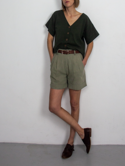 Woman wearing the Xanelé Shorts sewing pattern from French Navy on The Fold Line. A shorts pattern made in linen, linen blends, hemp, tencel or chambray fabrics, featuring an elasticated waistband with belt loops, pleated front, cuffed hem and mid-thigh length.
