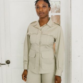 Women wearing the 130 Unisex Australian Bush Outfit sewing pattern from Folkwear on The Fold Line. A unisex shorts and jacket pattern made in poplin, denim, chino, sailcloth, medium-weight linen or light-weight wool gabardine fabrics, featuring a hip length jacket with front button closure, pointed collar and lapels, front darts and shaped side-back seams, back pleats, back yoke, two piece sleeves pleated into buttoned cuffs, buckled belt, pockets and deep flap pockets. The shorts have buttoned front fly closing, pleated into wide waistband, buckled belt tabs, deep angled side pockets, button-flap back pockets and above knee turned up hems.