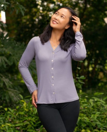 Woman wearing the Foz Top sewing pattern from Itch to Stitch on The Fold Line. A knit top pattern made in cotton spandex jersey or poly spandex jersey fabrics, featuring front button closure, full length sleeves and V-neck.