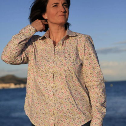 Woman wearing the Anna Shirt sewing pattern from Wardrobe by Me on The Fold Line. A shirt pattern made in cotton, linen or silk fabrics, featuring a relaxed fit, front button closure, yoke, pointed collar and stand, full length sleeves with button cuffs and curved high-low hem.