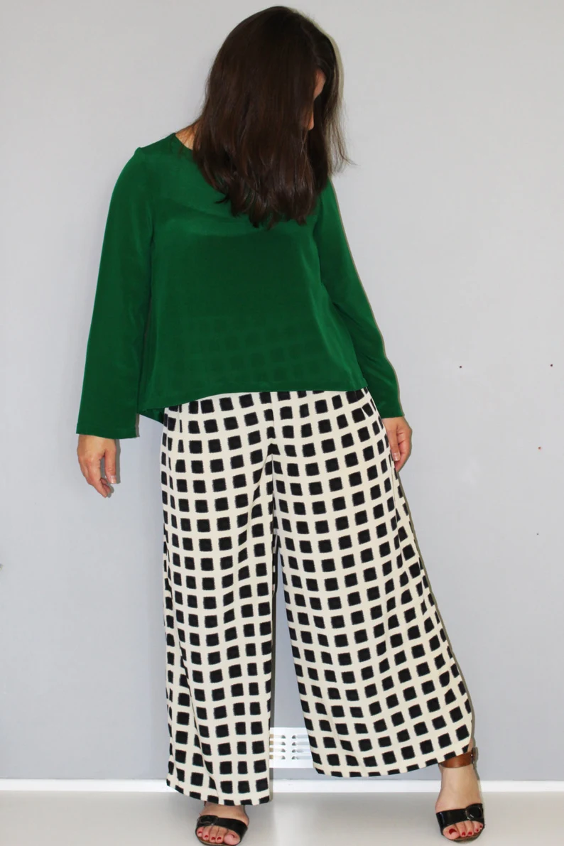 Woman wearing the Mercury Collection pattern from Marilla Walker on The Fold Line. A top and trouser pattern made in cotton, linen, viscose, silk, rayon, double gauze, crepe or chambray, fabrics, featuring trousers with a high waist, wide legs and half elastic back waist. The top has long sleeves, round neck and back split.