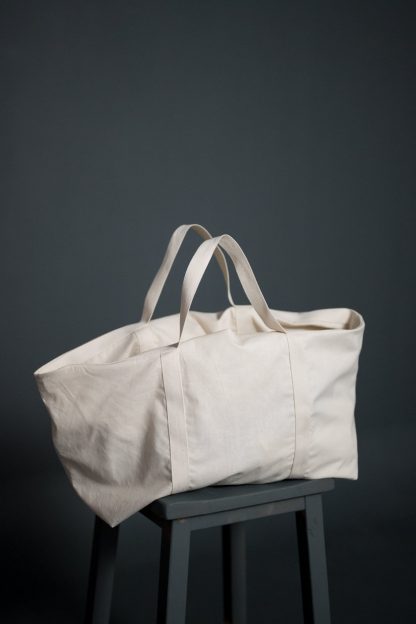 Image showing the One and a Half Bag pattern from Merchant and Mills on The Fold Line. A bag pattern made in cotton canvas, denim, dry oilskin or linen fabrics, featuring an oversized silhouette and webbed handles.