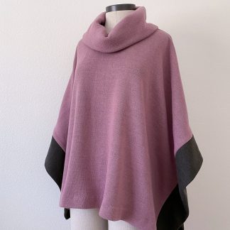 Mannequin wearing the Wintertide Poncho sewing pattern from Blue Dot Patterns on The Fold Line. A poncho pattern made in medium to heavy weight knits including ponte, sweater knit, sweatshirt fleece and French terry fabrics, featuring a cowl neck with open sides and contrast bands.