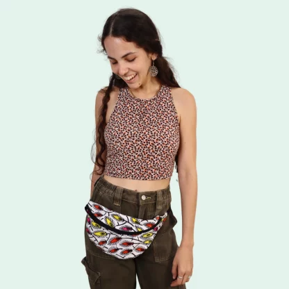 Woman wearing the Alex Fanny Pack sewing pattern from Sirena Patterns on The Fold Line. A waist bag pattern made in cotton denim or canvas fabrics, featuring a zip closure, adjustable webbing waistband, plastic buckle and fully lined.