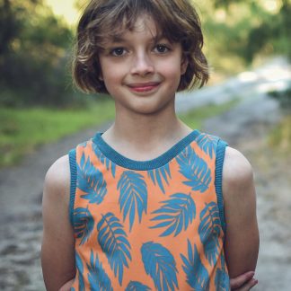 Child wearing the Amber Singlet sewing pattern from Waves & Wild on The Fold Line. A vest/tank pattern made in stretch knit fabrics, featuring a round neckline, no sleeves, neck and arm cuffs.