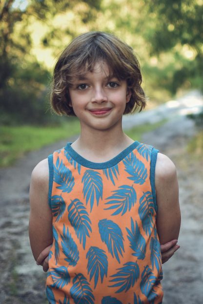 Child wearing the Amber Singlet sewing pattern from Waves & Wild on The Fold Line. A vest/tank pattern made in stretch knit fabrics, featuring a round neckline, no sleeves, neck and arm cuffs.