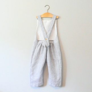 Child wearing the Baby/Child Beatnik Overalls sewing pattern from Elemeno Patterns on The Fold Line. A sleeveless overall pattern made in cotton knit or woven fabrics, featuring a relaxed fit, full length legs, elastic waistband on the back and one button for the shoulder straps.