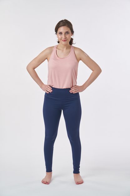 Woman wearing the Huby Leggings sewing pattern from Sew Over It on The Fold Line. A leggings pattern made in light to medium weight activewear knit fabrics, featuring no side seams, wide waistband, and full leg length.