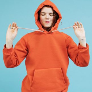 Women wearing the Unisex Maggi Sweater sewing pattern from Melilot on The Fold Line. A hoodie pattern made in medium to heavyweight weight knit fabrics, featuring a pattern to add a hood and kangaroo pocket to the Maggi Sweater.