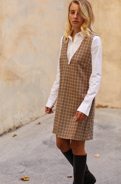 Women wearing the Ivy Dress sewing pattern from The Patterns Room on The Fold Line. A sleeveless dress pattern made in gabardine, wool or denim fabrics, featuring a loose fit, above knee length, deep V-neck and bust darts.
