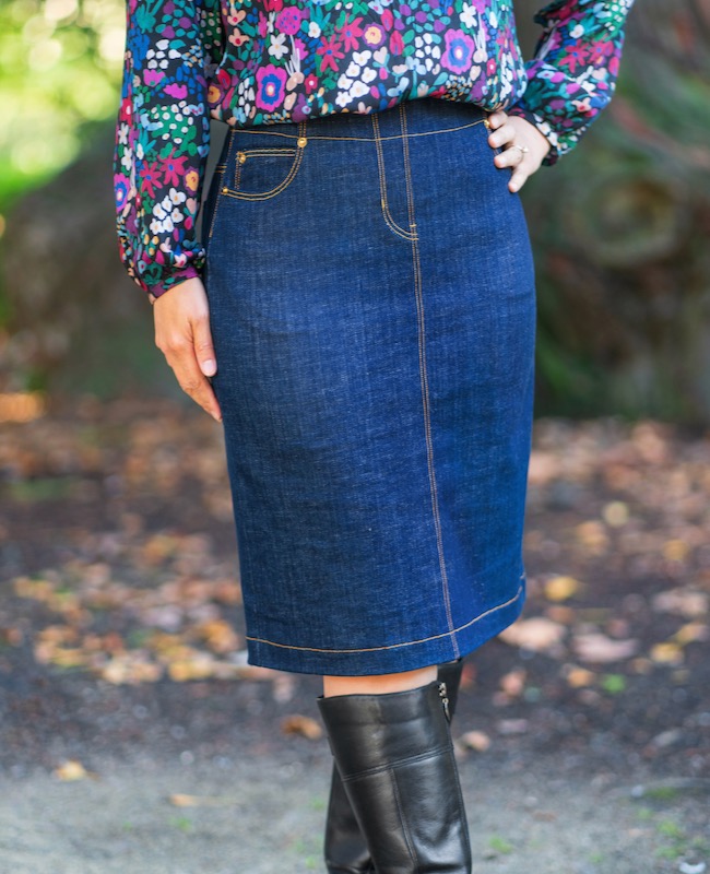 Woman wearing the Quebec Skirt sewing pattern from Itch to Stitch on The Fold Line. A skirt pattern made in stretch denim, twill, or corduroy fabrics, featuring a slim-fit, five pockets one coin, two front and two back pockets, a back split, elastic waist and knee length hem.