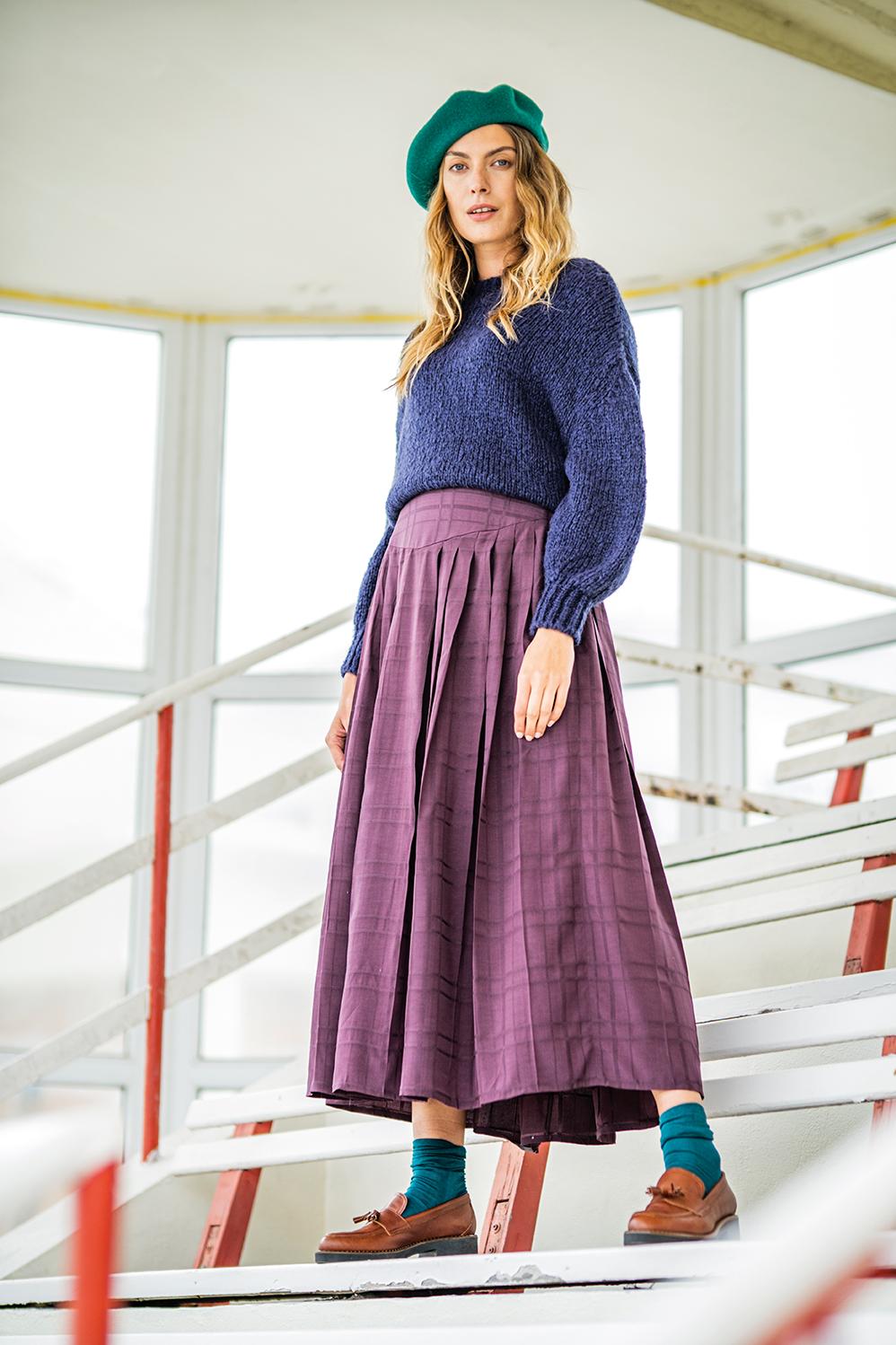 Woman wearing the Amira Skirt sewing pattern from Fibre Mood on The Fold Line. A skirt pattern made in polyester, polyamide or poplin fabrics, featuring pleats, fitted yoke, midi-length and side zip closing.
