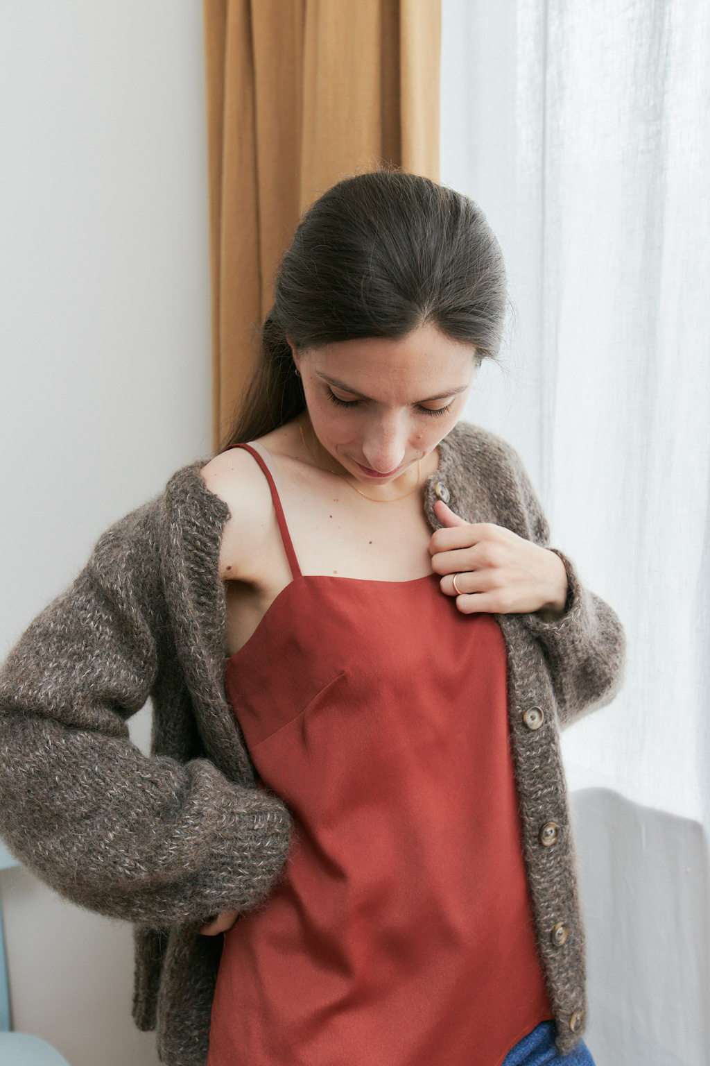 Woman wearing the Camisole sewing pattern from Camimade on The Fold Line. A camisole pattern made in cotton lawn, linen, crêpe de chine, silk, rayon or satin fabrics, featuring a loose fit, bust darts, spaghetti straps and slightly shaped low neckline.