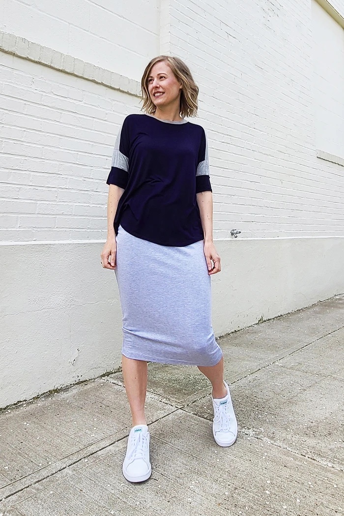 Woman wearing the Elemental Pencil Skirt sewing pattern from Sew House Seven on The Fold Line. A skirt pattern made in French terry, stretch sweatshirt fleece or cotton lycra fabrics, featuring a high waistband, elasticated waistband and below knee finish.