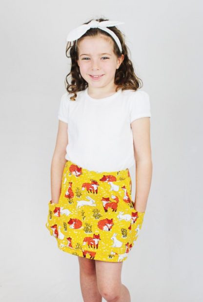 Child wearing the Children's Meadow Skort sewing pattern from Ruth Maddock Makes on The Fold Line. A skort pattern made in jersey fabrics, featuring a skirt with leggings underneath, elasticated waist and patch pockets.