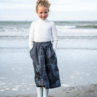 Child wearing the Child/Teen Olly Skirt sewing pattern from Fibre Mood on The Fold Line. A skirt pattern made in sweatshirting, cotton, lyocell, viscose (crepe) or double gauze fabrics, featuring a gathered elastic waistband and side pockets.