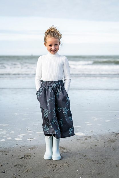 Child wearing the Child/Teen Olly Skirt sewing pattern from Fibre Mood on The Fold Line. A skirt pattern made in sweatshirting, cotton, lyocell, viscose (crepe) or double gauze fabrics, featuring a gathered elastic waistband and side pockets.