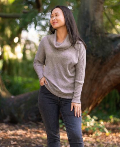Woman wearing the Sibiu Top sewing pattern from Itch to Stitch on The Fold Line. A top pattern made in jersey, sweater knit or French terry fabrics, featuring a batwing silhouette, relaxed fit, cowl neck and long sleeves.