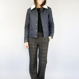 Woman wearing the Solstice Jacket sewing pattern from Atelier Scammit on The Fold Line. A jacket pattern made in medium to heavyweight wovens such as wool or jacquard fabrics, featuring slightly dropped shoulders, faux fur collar, high jetted pockets, full length sleeves and button front closure.