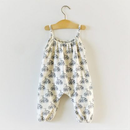 Image showing the Baby/Child Boho Romper sewing pattern from Elemeno Patterns on The Fold Line. A romper pattern made in woven or knit fabrics, featuring elasticated ankles, gathered front and back neck, relaxed fit and narrow shoulder straps