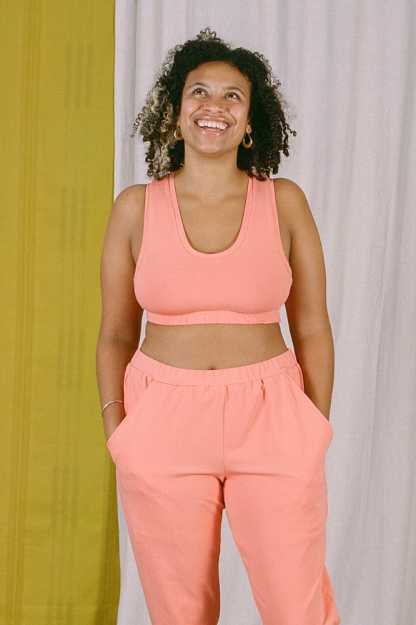 Woman wearing the Lottie Bra sewing pattern from Made My Wardrobe on The Fold Line. A bra pattern made in medium weight knit fabrics, featuring a racerback, scoop neck, broad straps and elasticated underband.