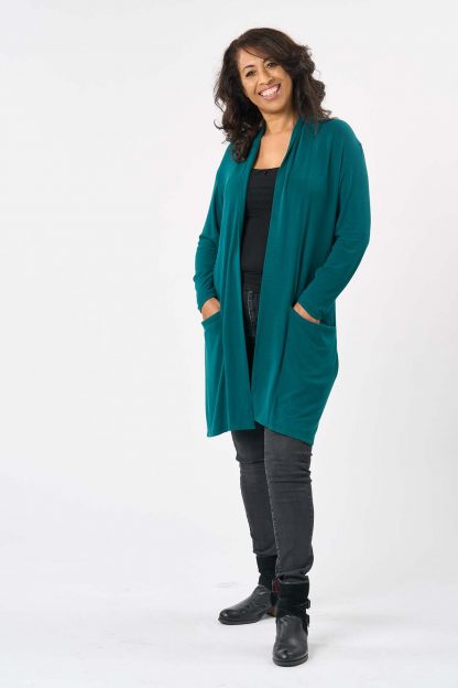 Woman wearing the Marni Cardigan sewing pattern from Sew Over It on The Fold Line. A cardigan pattern made in viscose or bamboo jersey, French terry or lightweight cotton jersey fabrics, featuring a long-line silhouette, drop shoulder, wide neckband, pockets and knee length.