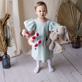Child wearing the Children’s Tania Dress sewing pattern from Kate’s Sewing Patterns on The Fold Line. A dress pattern made in cotton or linen fabrics, featuring double shoulder ruffles, gathered skirt, lined bodice and round neckline.