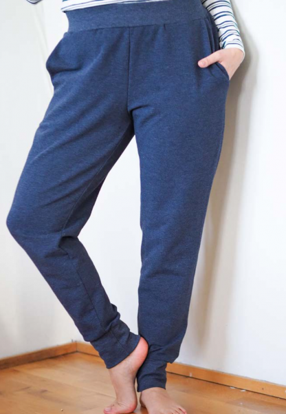Woman wearing the Fieldfare Joggers sewing pattern from Pattern by Malena on The Fold Line. A joggers pattern made in medium weight knit jersey fabrics, featuring an elasticated waistband, full length leg with wide ankle cuffs, slanted pockets and a relaxed fit.
