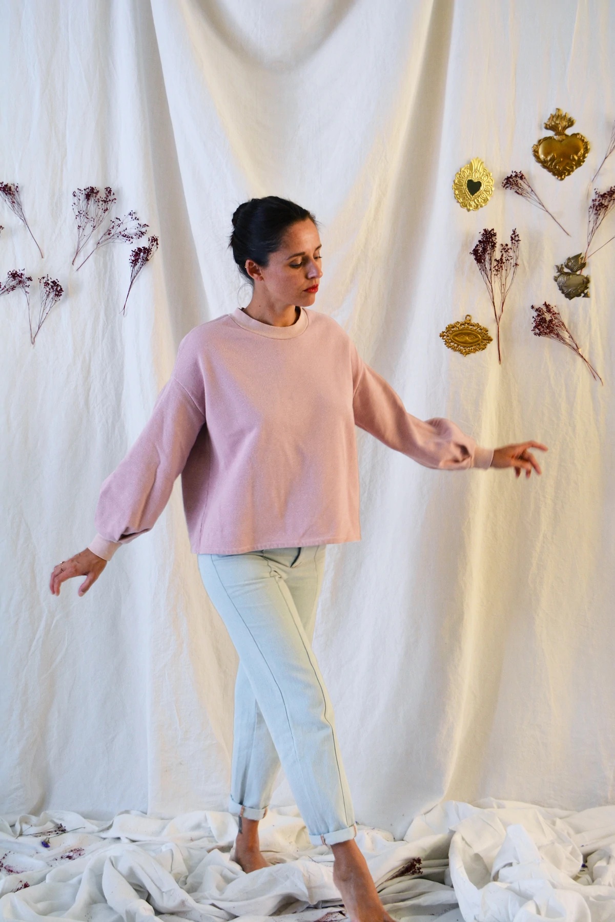 Woman wearing the Granite Sweatshirt sewing pattern from Maison Fauve on The Fold Line. A sweatshirt pattern made in Jersey, knit or sweatshirt fabrics, featuring a boxy silhouette, full length voluminous sleeves, round neck and ribbed cuffs and neck.