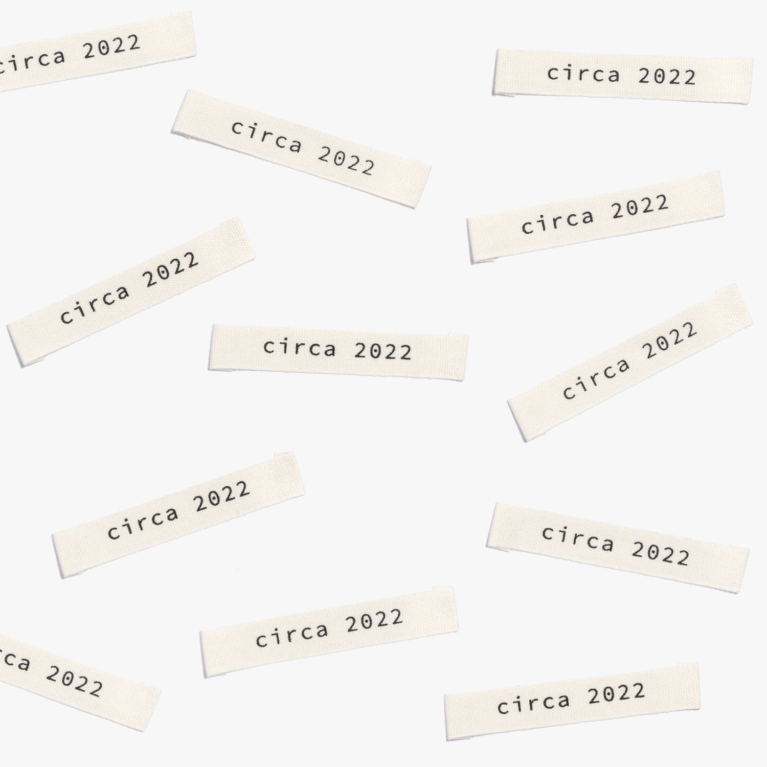 Photo showing 'Circa 2022' Cotton Labels from Kylie & The Machine on The Fold Line. A washable, durable and non-scratchy fabric label featuring the words 'Circa 2022' all ready to be sewn into your handmade clothes.