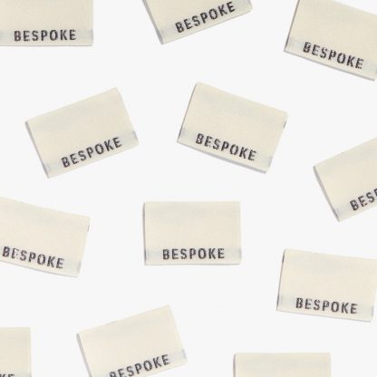 Photo showing 'Bespoke' Woven Labels from Kylie & The Machine on The Fold Line. A washable, durable and non-scratchy fabric label featuring the word 'Bespoke' all ready to be sewn into your handmade clothes.