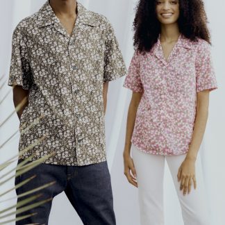 Man and Woman wearing the Unisex Como Collar Shirt sewing pattern from Liberty Sewing Patterns on The Fold Line. A shirt pattern made in lawn cotton, chambray, silk or linen fabrics, featuring a back yoke, optional bust darts and pockets, short sleeves, collar and stand, front button closure and straight or curved hem.