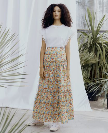 Woman wearing the Megan Maxi Skirt sewing pattern from Liberty Sewing Patterns on The Fold Line. A skirt pattern made in lawn cotton, chambray, crepe de chine or linen fabrics, featuring a maxi length, elasticated waistband and two gathered tiers.