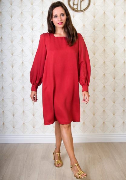 Woman wearing the Lauren Dress and Blouse sewing pattern from Maison Fauve on The Fold Line. A dress pattern made in viscose, fine wool, cotton, tencel, linen or silk fabrics, featuring a pleated shoulder, square neckline, long buttoned cuff with gathered sleeves, knee length, relaxed fit.